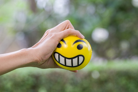 Hands of a woman squeezing a stress ballの写真素材