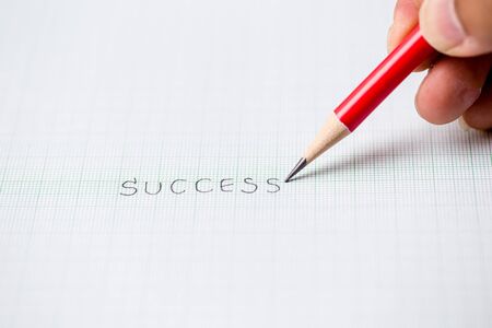 Success sketch text written red pencil graph paper backgroundの写真素材