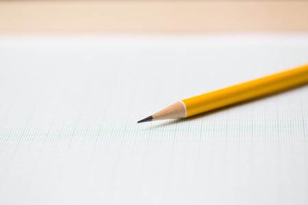 close-up yellow pencil on graph paper backgroundの写真素材