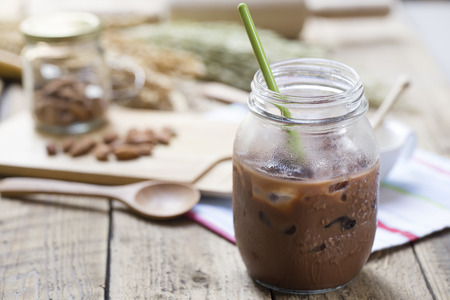 Cold Chocolate Milk drink (close-up shot) on wooden backgroundの写真素材