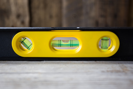 yellow building level on the wood tableの写真素材