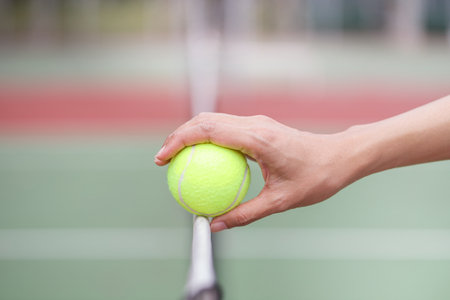 Tennis ball on net at tennis courtの写真素材