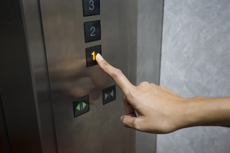 businesswoman hand press 1 floor in elevator