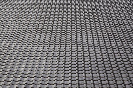Black tiled roof for background usageの写真素材