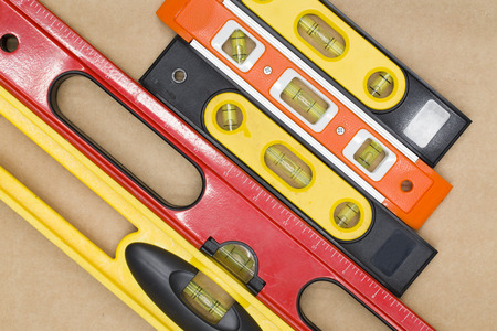 red and yellow building level on the brown paper background