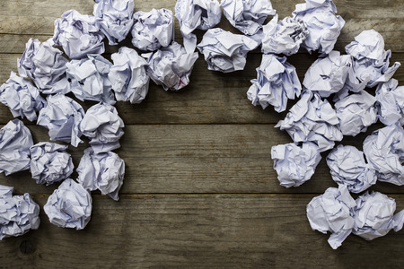 a lot of paper ball on wood table backgroundの写真素材