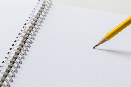 close-up yellow pencil on graph paper backgroundの写真素材