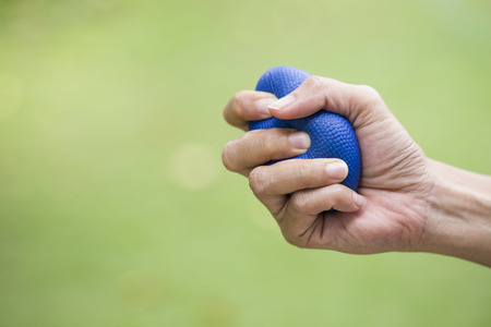 Woman hand squeezing a stress ballの写真素材