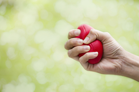 Woman hand squeezing a stress ballの写真素材