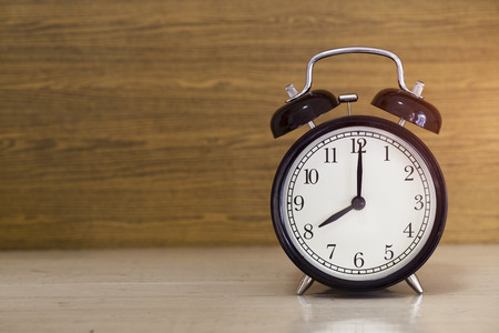 Retro alarm clock on wooden table