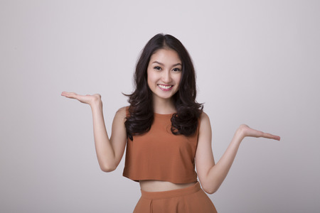 happy young woman presenting on copy spaceの写真素材