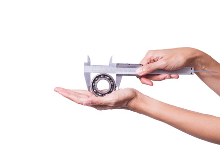Female engineer use vernier to measure old bearing on white background