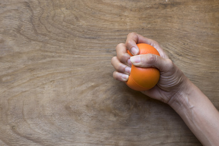 Hands of a woman squeezing a stress ballの写真素材