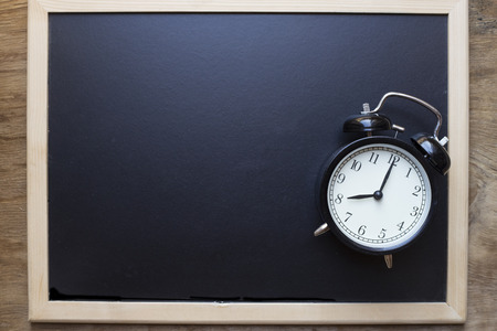 Retro alarm clock on blackboard