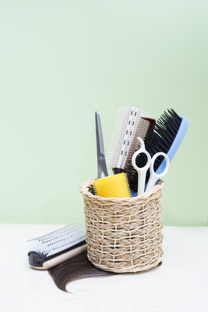 hairdresser tools on wood table with green backgroundの写真素材