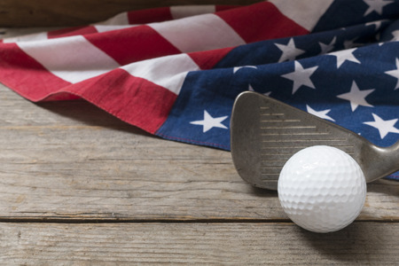 Golf ball with flag of USA on wood tableの写真素材