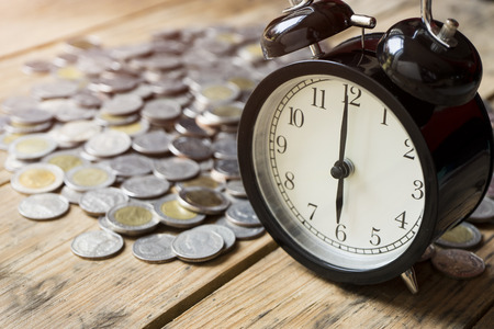 time and money on wood table, concept and ideaの写真素材