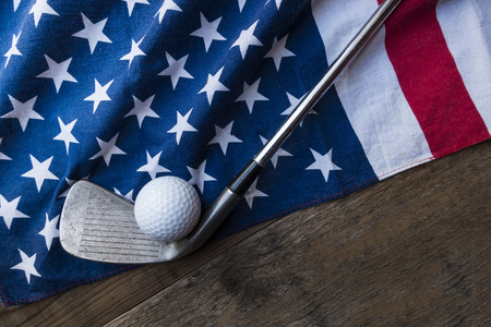 Golf ball with flag of USA on wood tableの写真素材