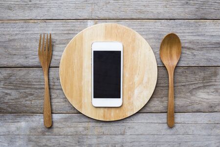 mobile phone served on wood plate. Concept and idea