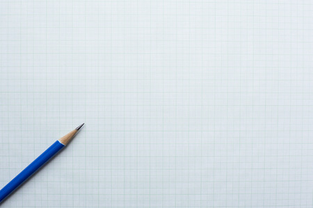 close-up blue pencil on graph paper backgroundの写真素材