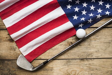 Golf ball with flag of USA on wood tableの写真素材