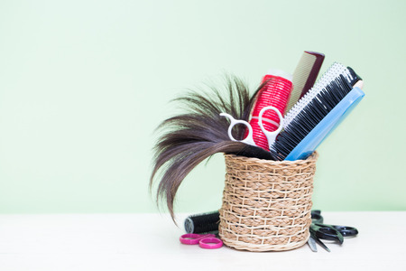 hairdresser tools on wood table with green backgroundの写真素材