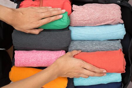 woman packing a luggage for a new journeyの写真素材