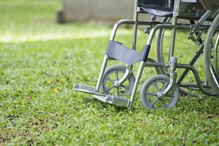 Empty wheelchair parked in parkの写真素材