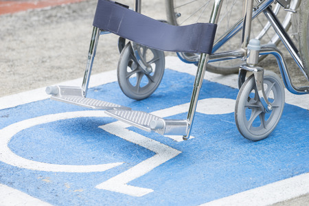 Pavement handicap symbol and wheelchairの写真素材