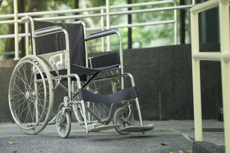Empty wheelchair parked in hospitalの写真素材