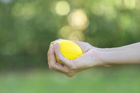 Hand of a woman squeezing a stress ballの写真素材