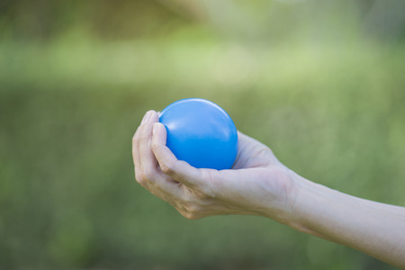 Hand of a woman squeezing a stress ballの写真素材