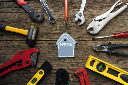 DIY home and construction tools on a wooden background