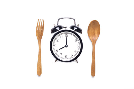 Meal time with alarm clock, breakfast on white backgroundの写真素材