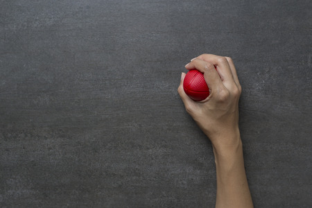 Hands of a woman squeezing a stress ballの写真素材
