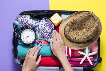 woman packing a luggage for a new journeyの写真素材