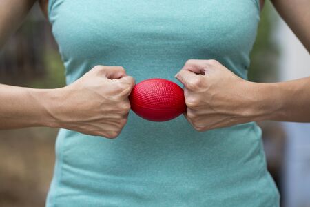 Hands of a woman holding a stress ballの写真素材