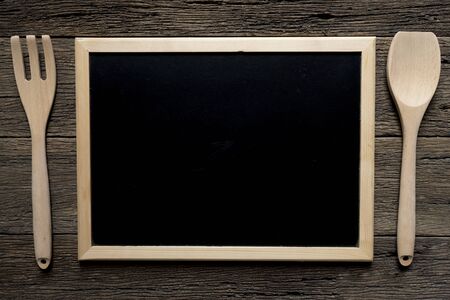 Empty with wooden fork and spoon on table backgroundの写真素材