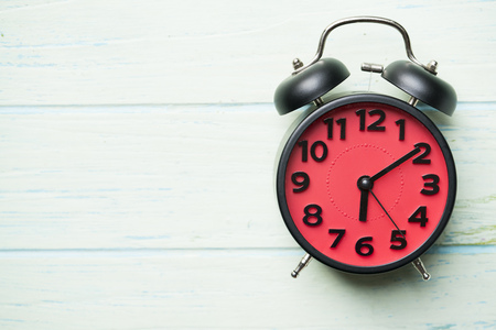 Retro alarm clock on wooden tableの写真素材