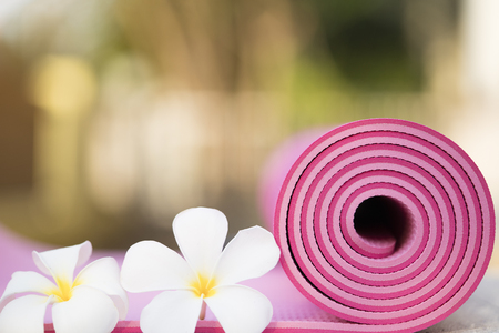 pink yoga mat and a flowersの写真素材