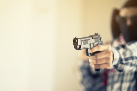 Hand of terrorist holding a gunの写真素材