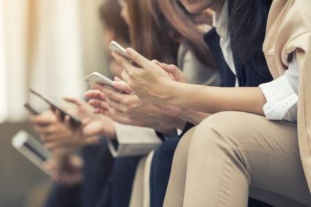Close up of businessmen and businesswomen using smartphone, business conceptの写真素材