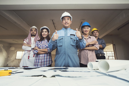 Asian engineers were consulted together and plan in construction siteの写真素材