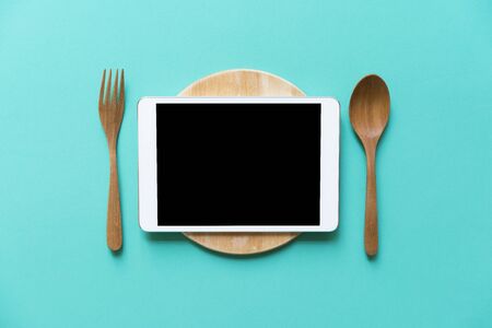 tablet device served on wood plate, concept and ideaの写真素材