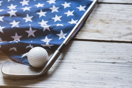 Golf ball with flag of USA on wood tableの写真素材