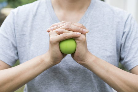 woman hand holding a stress ball の写真素材