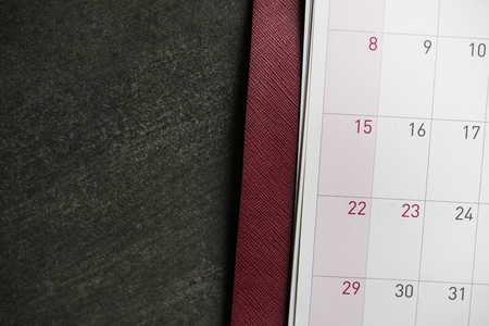 calendar on the black table background, planning concept