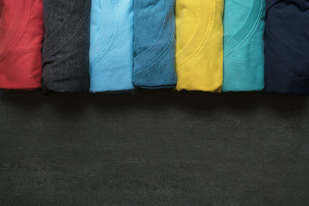 close up of rolled colorful clothes on black backgroundの写真素材