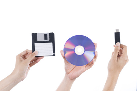 Floppy disk, CD or DVD disc and flash/ thumb drive comparision concept on isolated white background