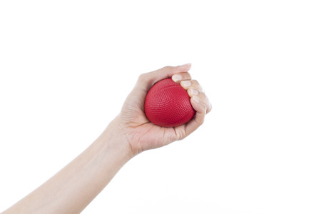 woman hand holding red stress ball on white background